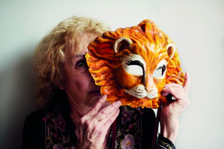 Carolee Schneemann holding a Venetian lion mask, photographed in London in May 2017, Photo: Benjamin McMahon