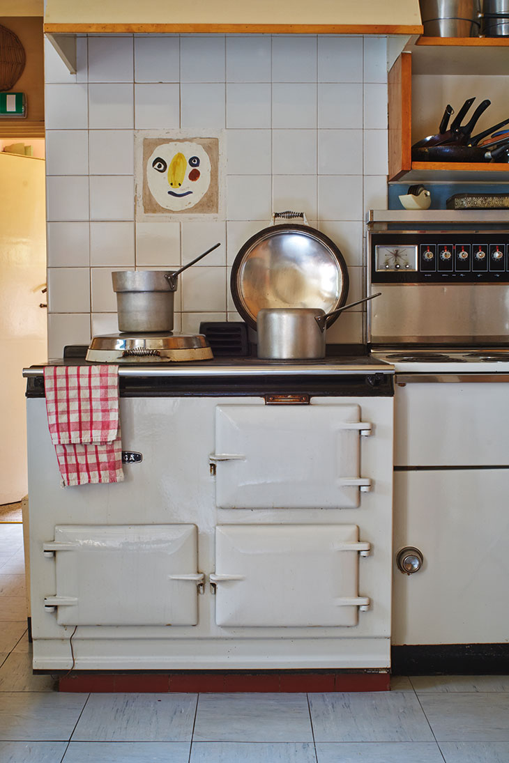 The kitchen at Farleys, East Sussex, with a tile by Picasso above the Aga.